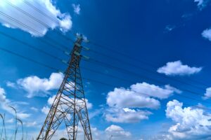 Power transmission tower under blue sky representing Kansai Electric’s energy infrastructure in Japan