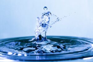 A high-speed capture of a water droplet splash, symbolizing purity, precision, and the ripple effect — ideal for articles on innovation, sustainability, or impact investing.